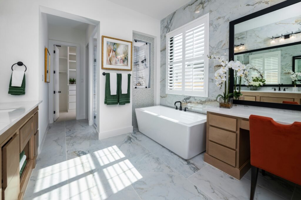 Modern bathroom remodel with marble tile flooring, wooden cabinets, and a white bathtub in Bonita Springs.