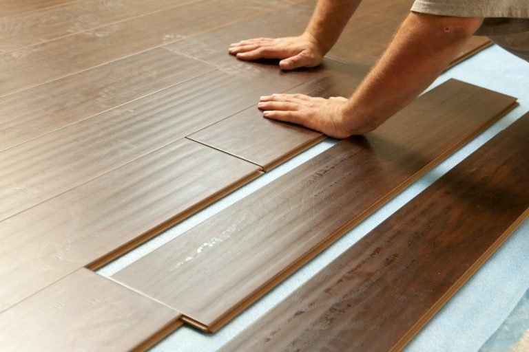 A Handyman installing new flooring in an Old Naples home.