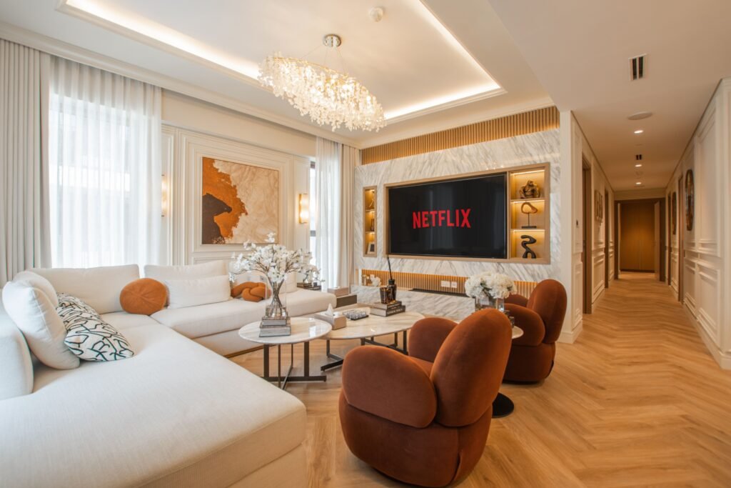 Modern living space with a white couch, wood floors and a chandelier in Estero.
