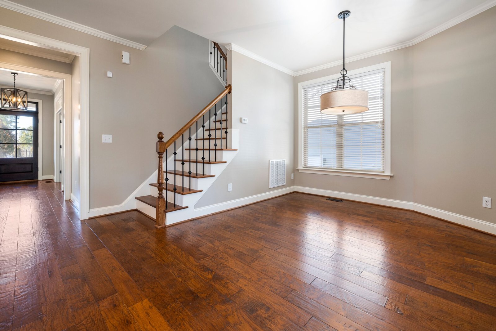 A room with wood floors, tan walls, and white baseboards in Marco Island.