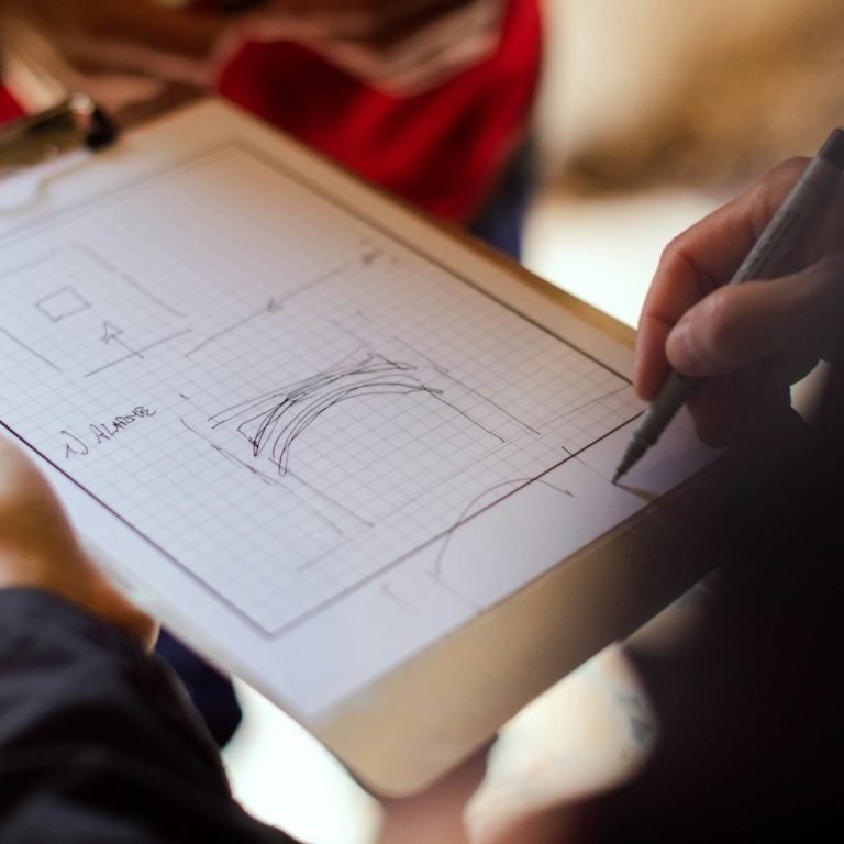 Contractor holding a clipboard with remodel sketches on the paper.