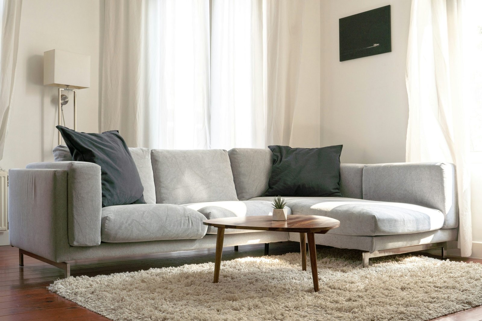 A grey couch in a bright living room in Naples.
