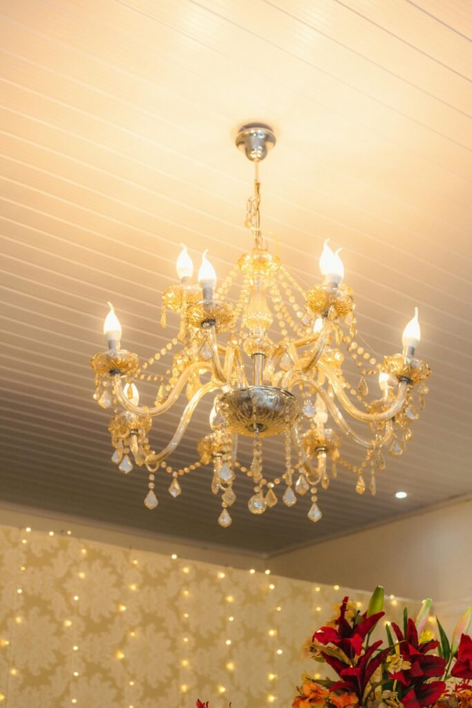 Elegant chandelier with multiple lights and decorative crystals hanging from the ceiling installed in an Old Naples home.