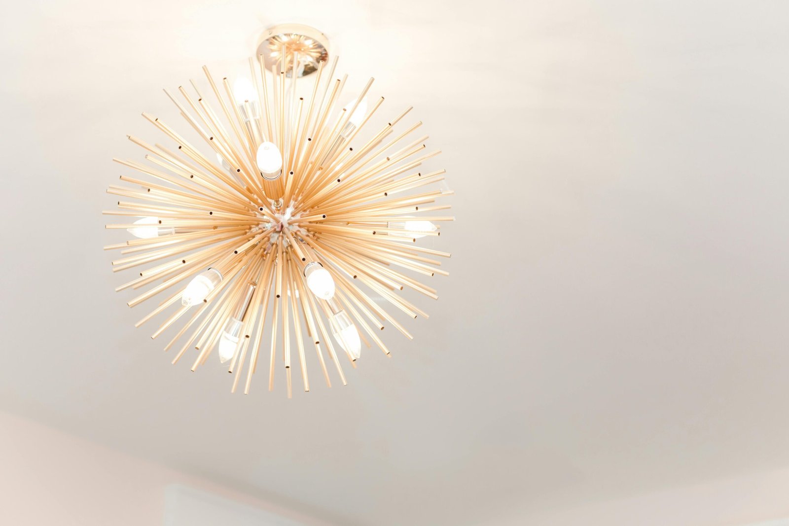 A Modern, abstract, gold light fixture installed in Marco Island.