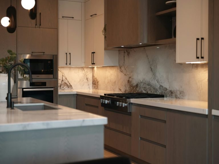 A modern kitchen with mostly brown cabinets, marble backsplash and countertops in Bonita Springs.