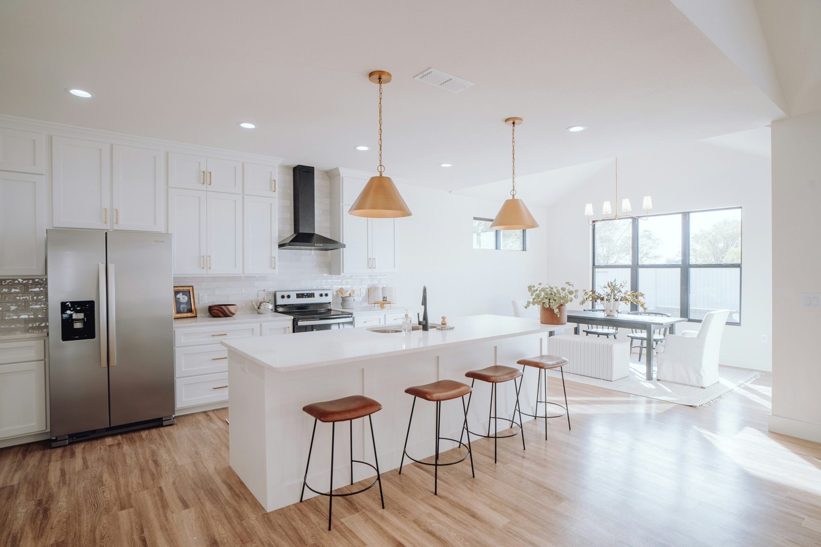 A modern kitchen with white cabinets, white countertops, and an island in Golden Gate Naples.