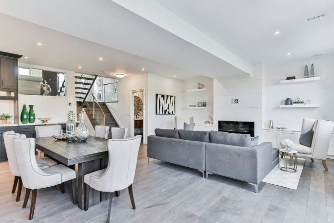 Modern living room and dining area with light colors, a dining table, and stylish furniture in Naples, FL.