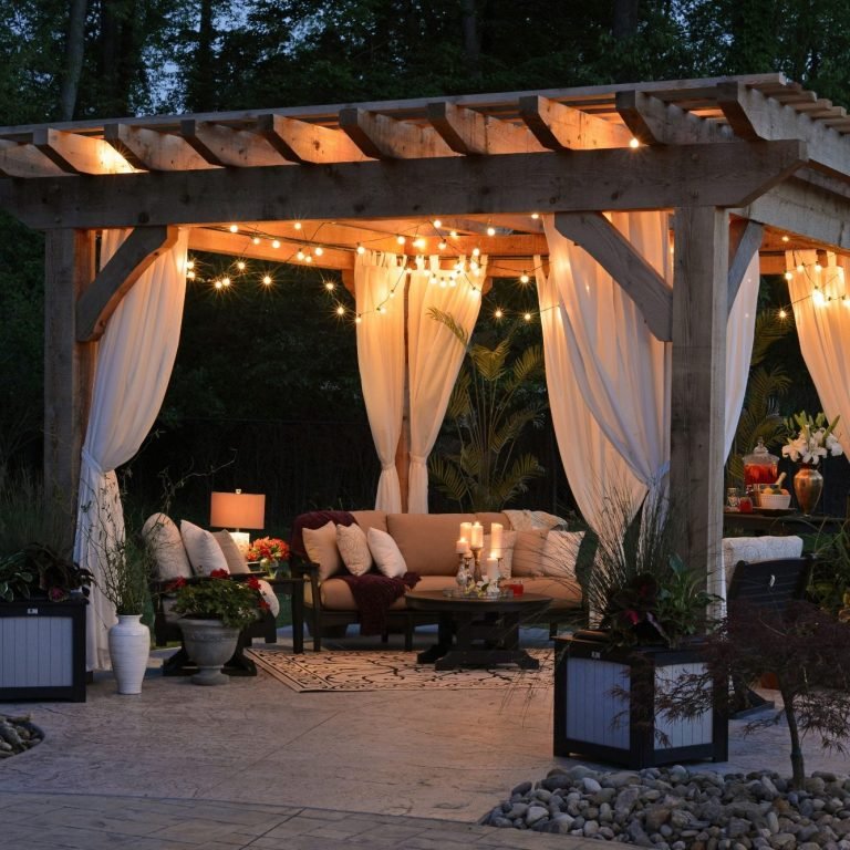 A cozy outdoor seating area with a pergola, new tile, and curtains in Old Naples.