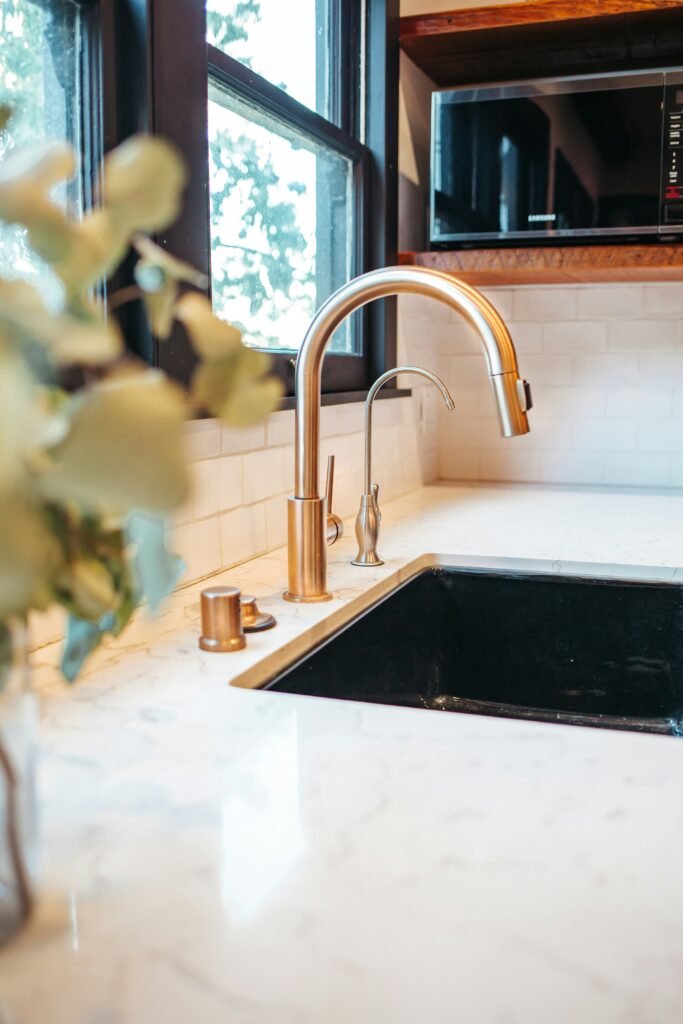 New, gold, faucet installed in a Bonita Springs kitchen.
