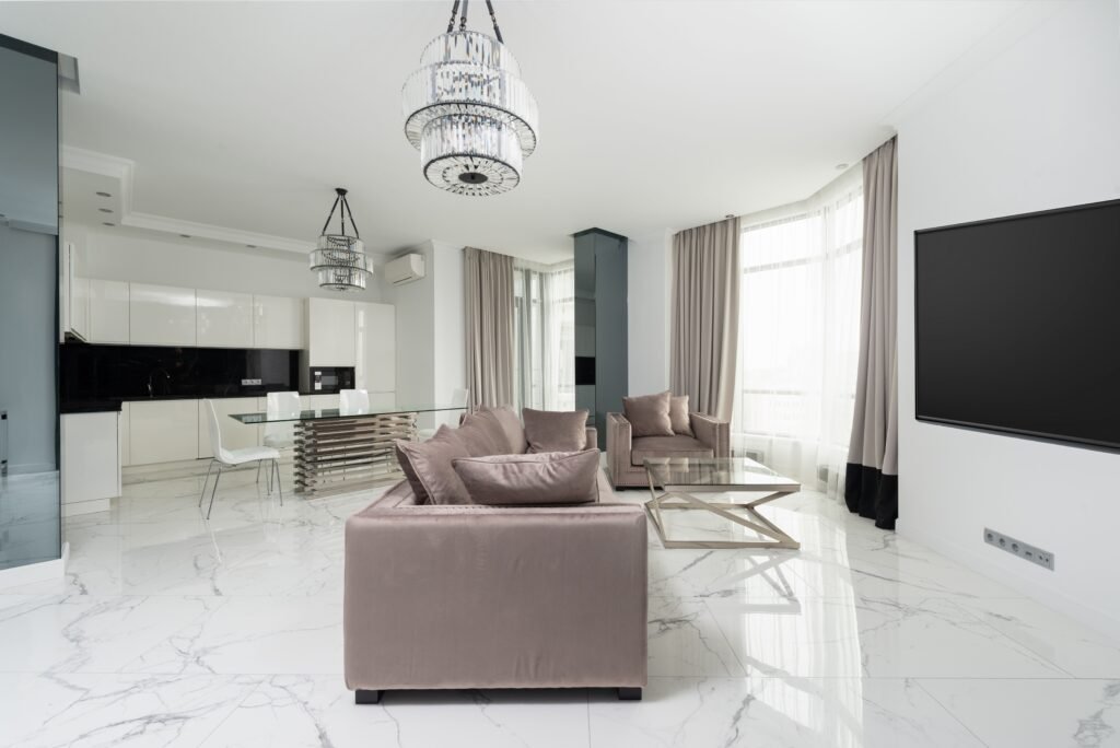 Modern living room with grey sofas, marble floor, and minimalist decor in Marco Island.