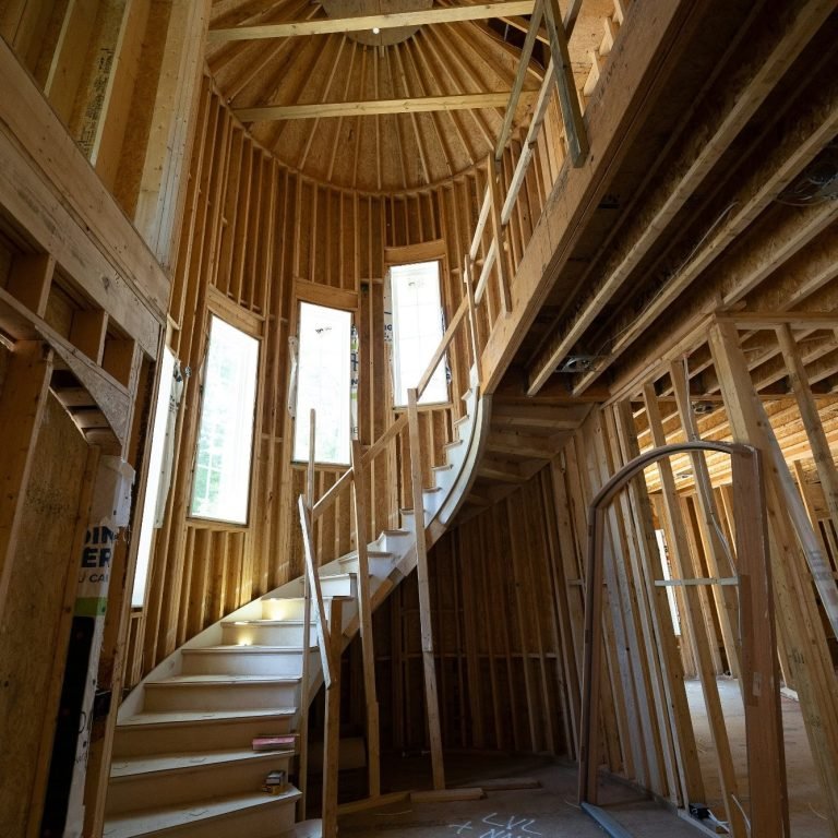A framed out, spiral, staircase being built inside a North Naples home.
